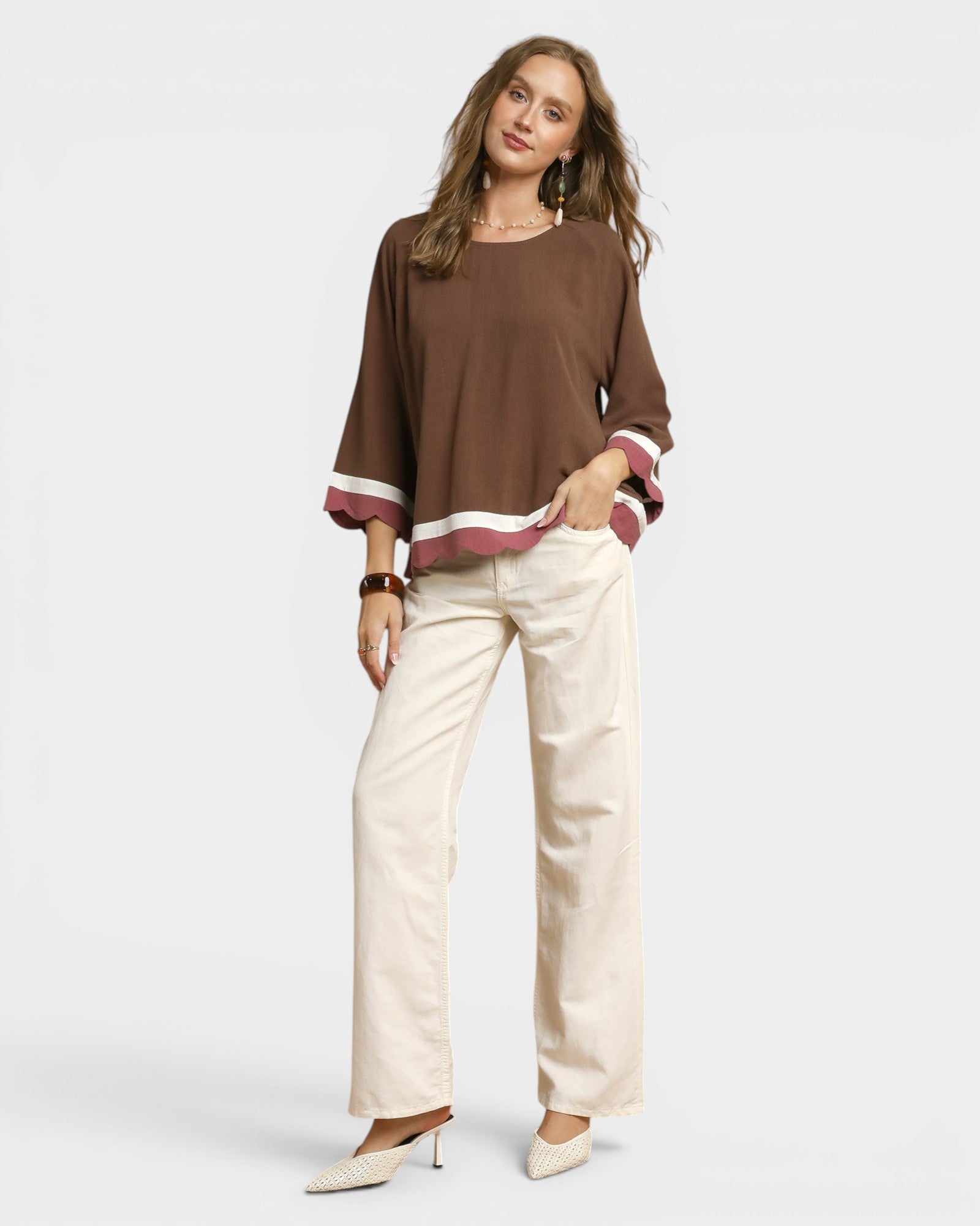 Woman wearing a brown top with a white background