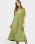 Woman wearing a green dress with white trim on a white background