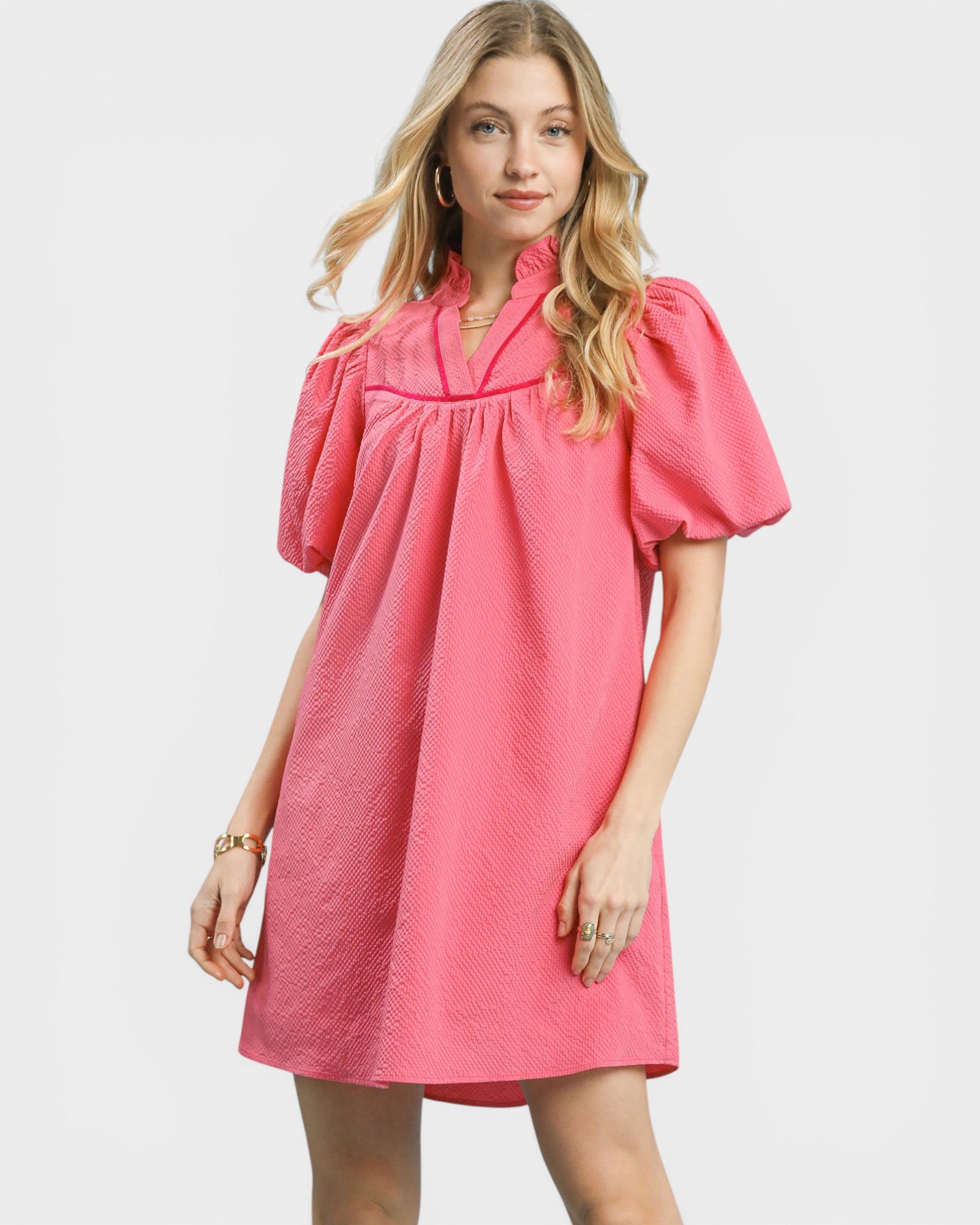 Woman wearing a pink dress on a white background