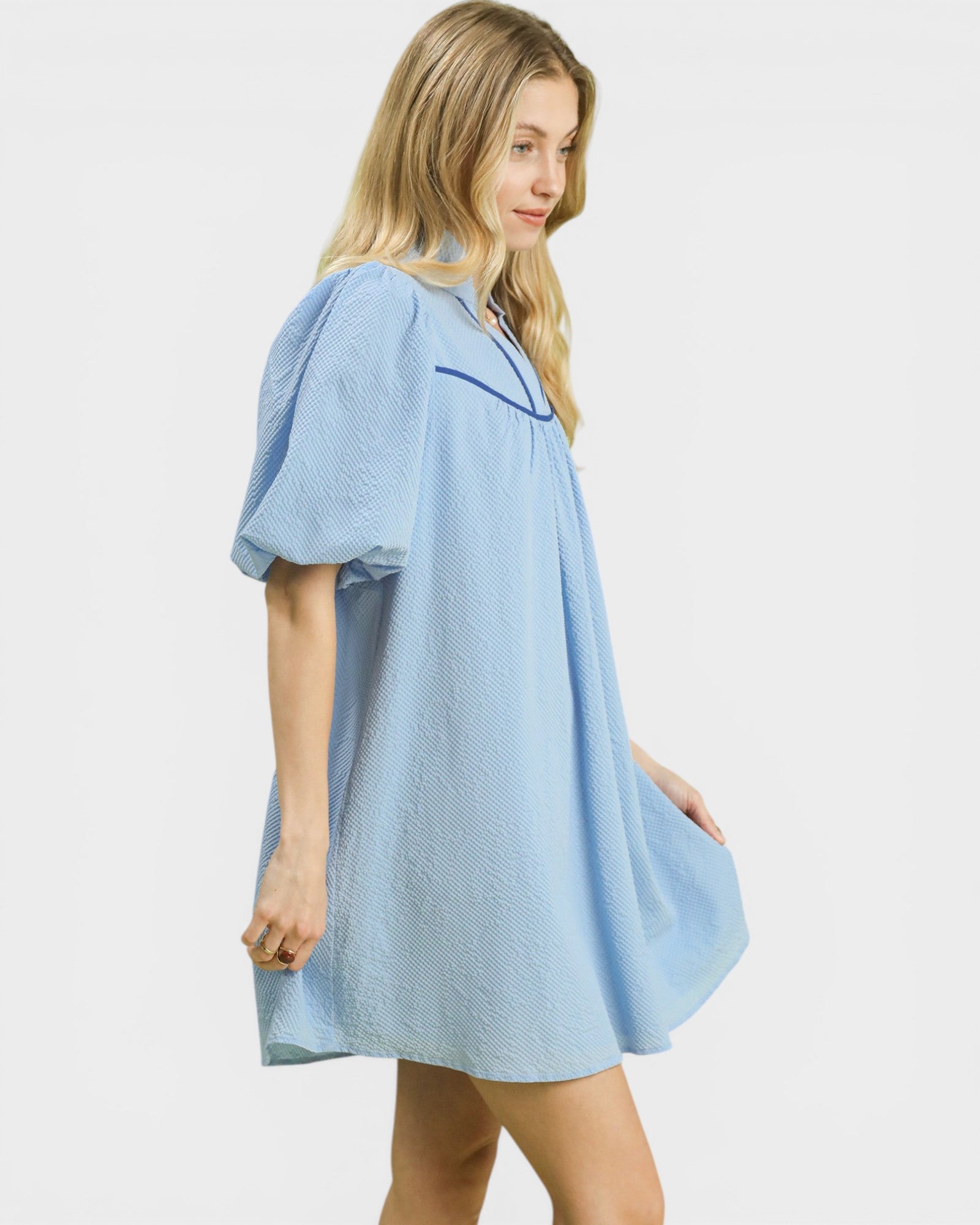 Woman wearing a light blue nightgown on a white background