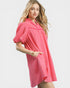 Woman wearing a pink dress with ruffled sleeves on a white background