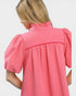 Pink textured blouse with puff sleeves on a white background