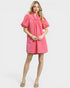 Woman wearing a pink dress on a white background