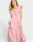 Woman wearing a pink dress with ruffled details on a white background