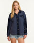 Woman wearing a navy blue shirt with sequin details on a white background