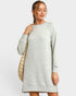 Woman wearing a gray sweater dress against a white background
