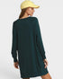 Person wearing a dark green dress and yellow cap on a white background
