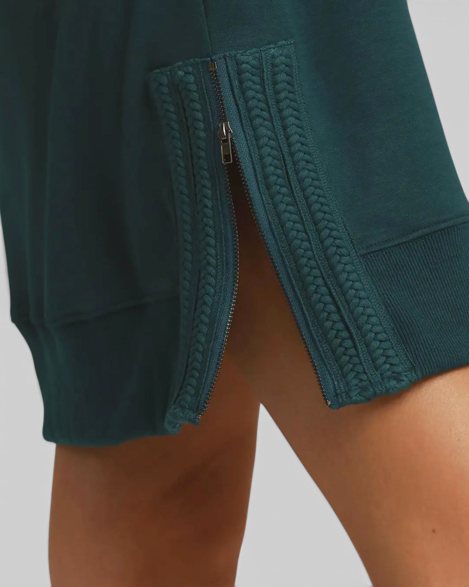 Teal shorts with a textured pattern on a plain background