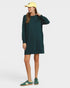 Person wearing a green dress and yellow cap on a white background
