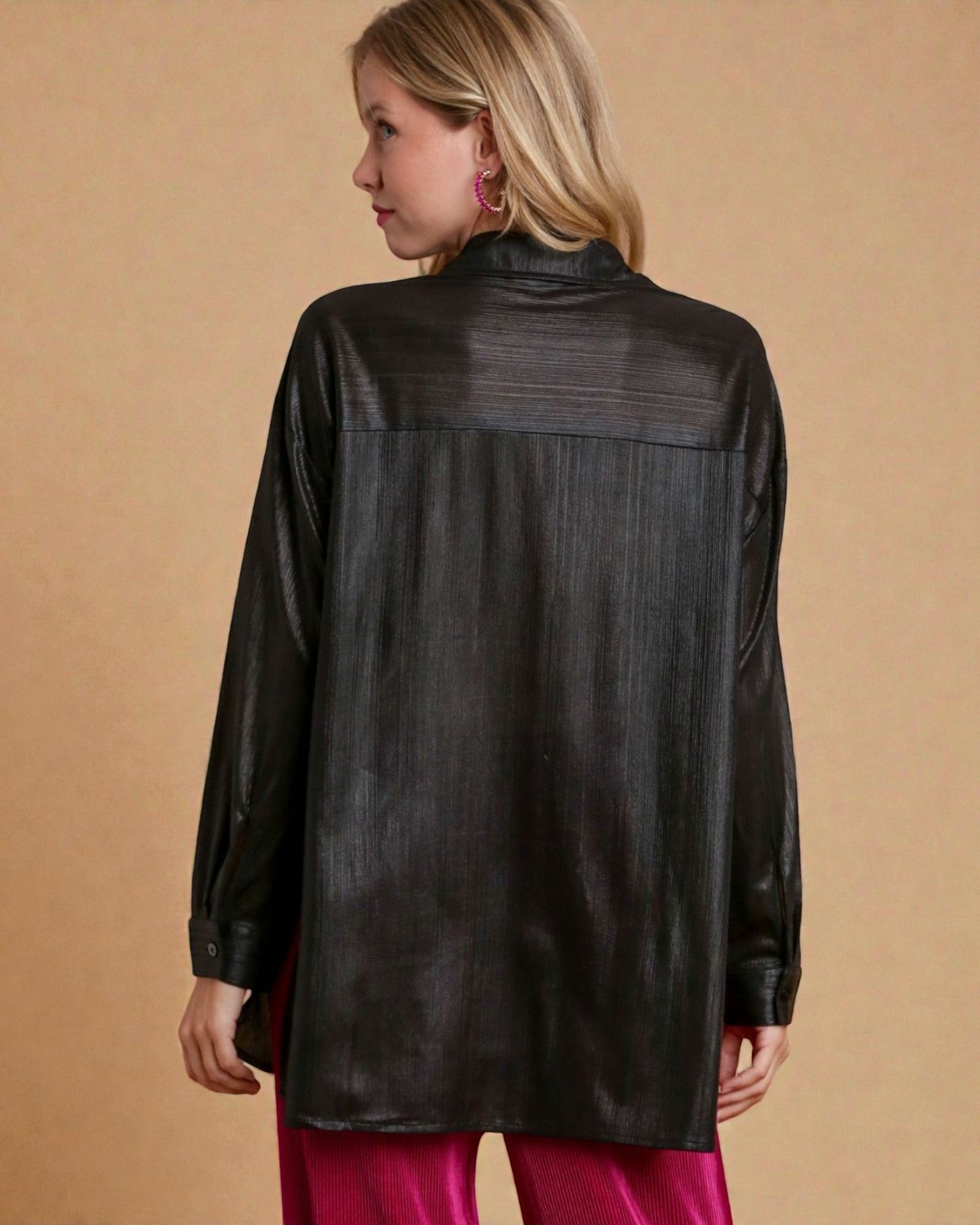 Woman wearing a black leather jacket on a beige background