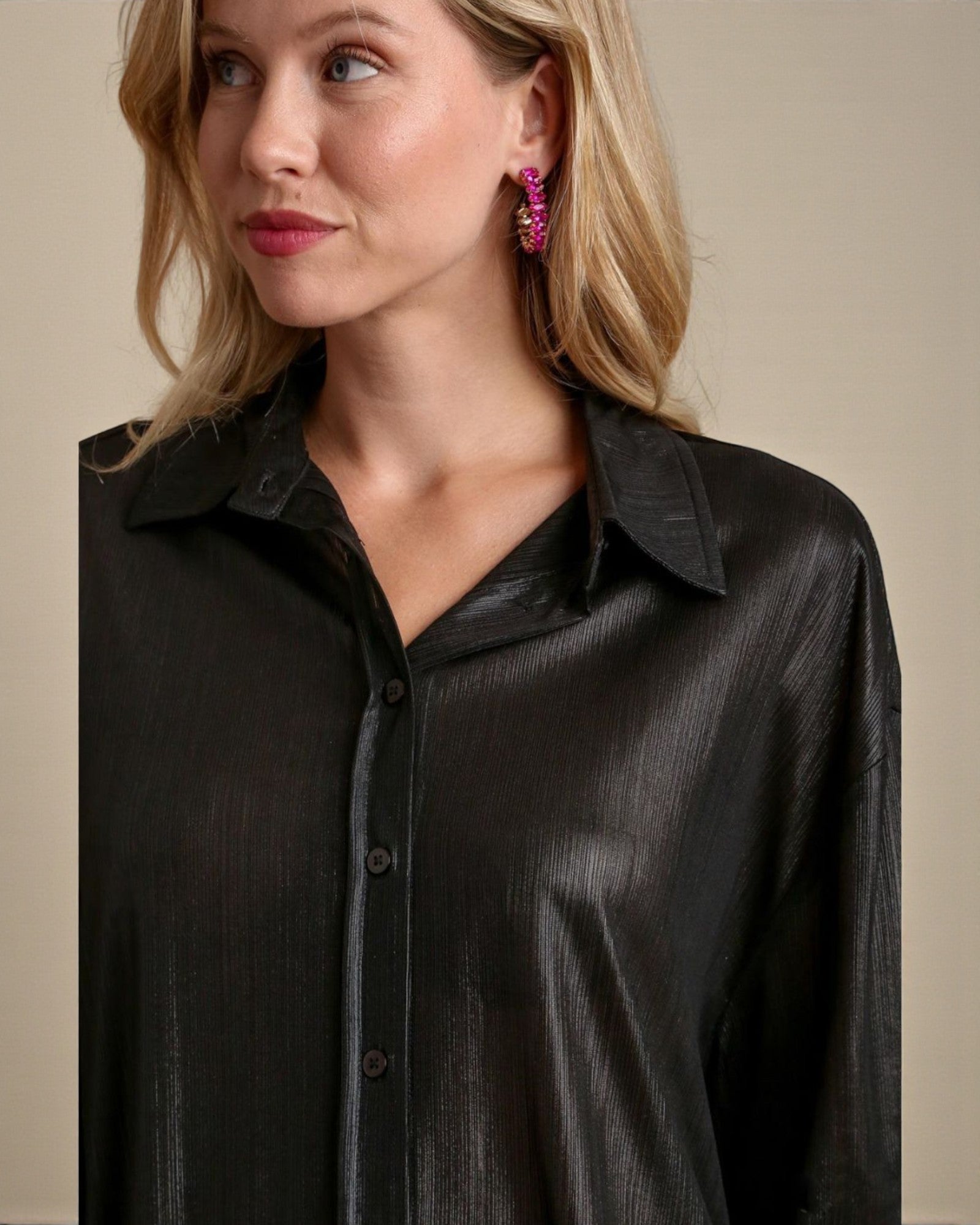 Woman wearing a black shirt against a beige background