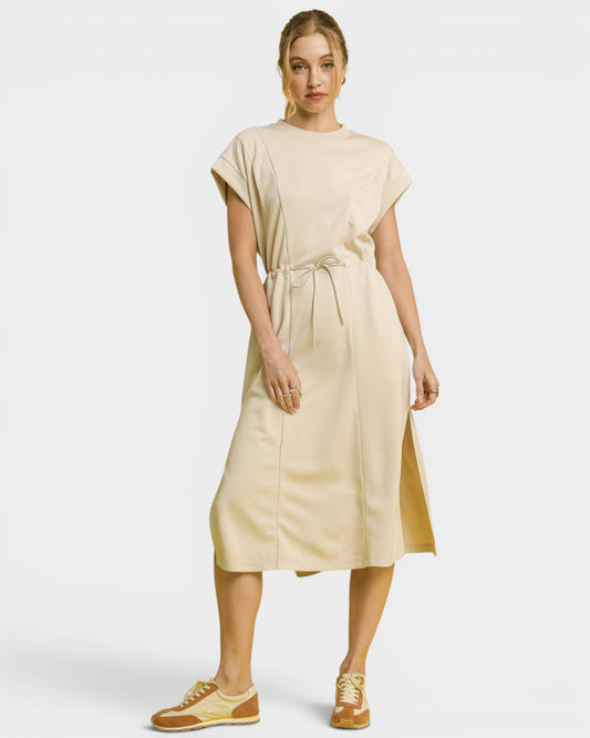 Woman wearing a beige dress on a white background