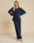Woman wearing a navy blue textured outfit on a beige background