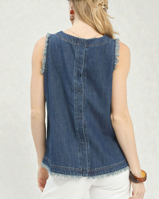 Denim sleeveless top worn by a person on a plain background