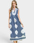 Woman wearing a blue dress with white floral patterns on a white background