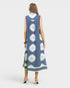Woman wearing a blue dress with white floral patterns on a white background