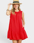 Woman wearing a red dress and a straw hat on a white background