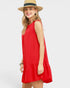 Woman wearing a red dress and straw hat on a white background