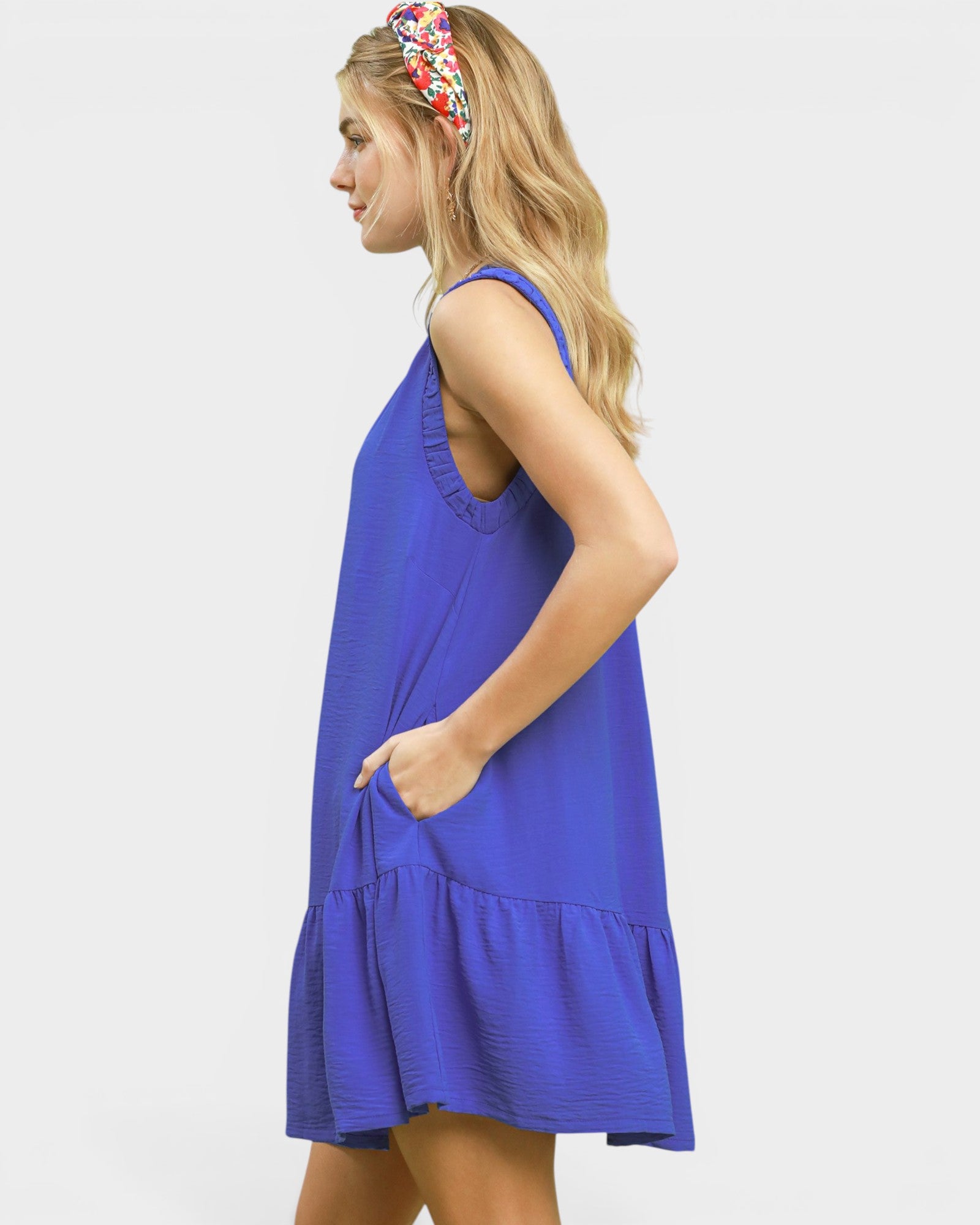 Woman wearing a blue dress with a white background