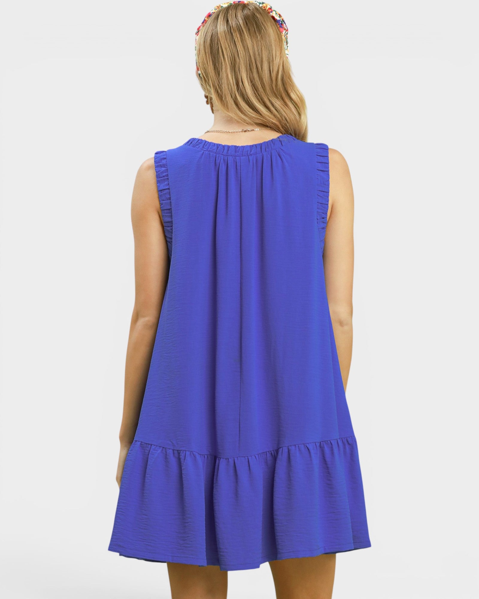 Blue dress worn by a person on a white background