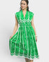 Woman wearing a green and white patterned dress on a white background