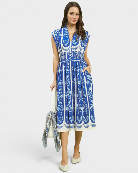 Woman wearing a blue and white patterned dress on a white background