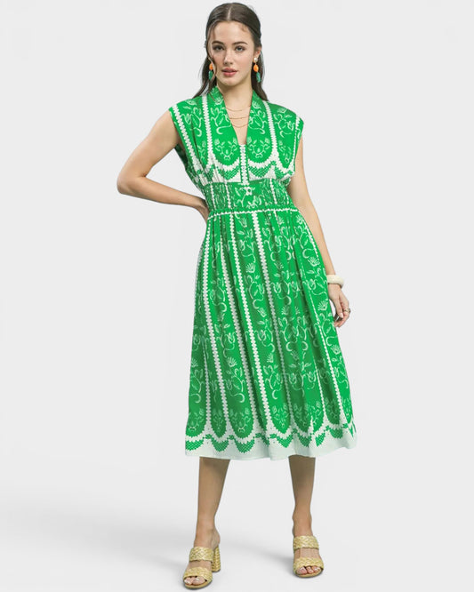 Woman wearing a green and white patterned dress on a white background
