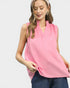 Woman wearing a pink sleeveless top and blue jeans on a white background