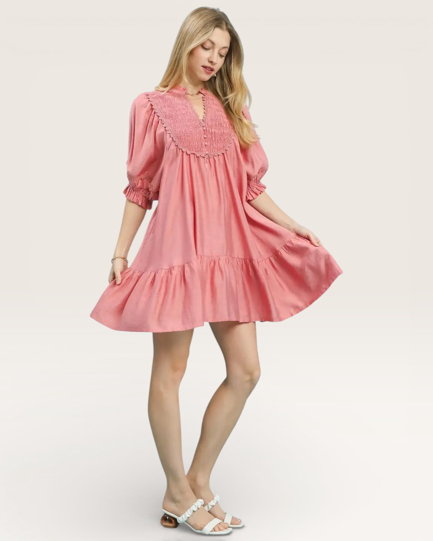 Woman wearing a pink dress on a white background