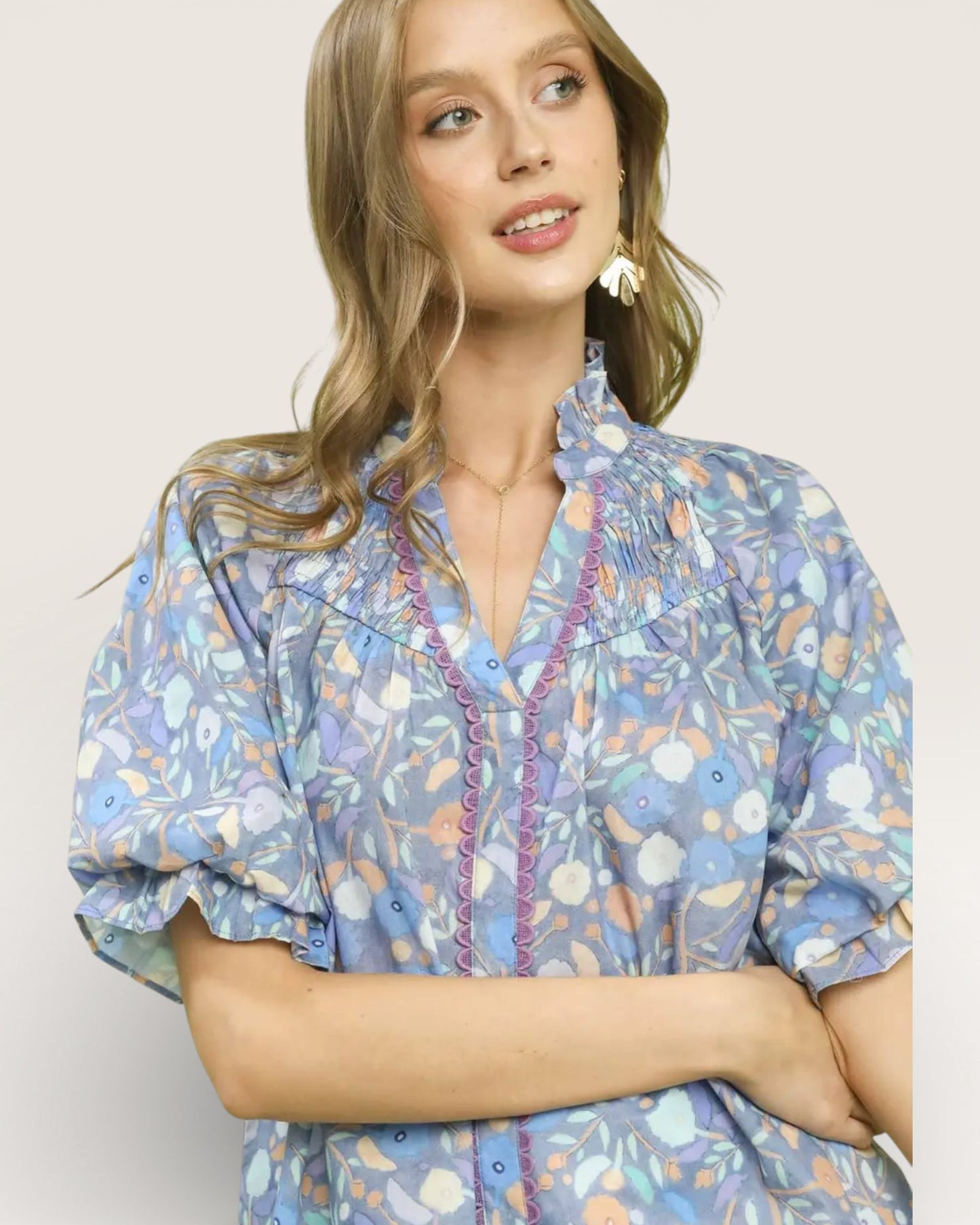 Woman wearing a floral blouse with a plain background