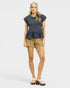 Woman wearing a dark blue peplum top and beige shorts on a white background