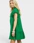 Woman wearing a green dress with ruffled details on a white background