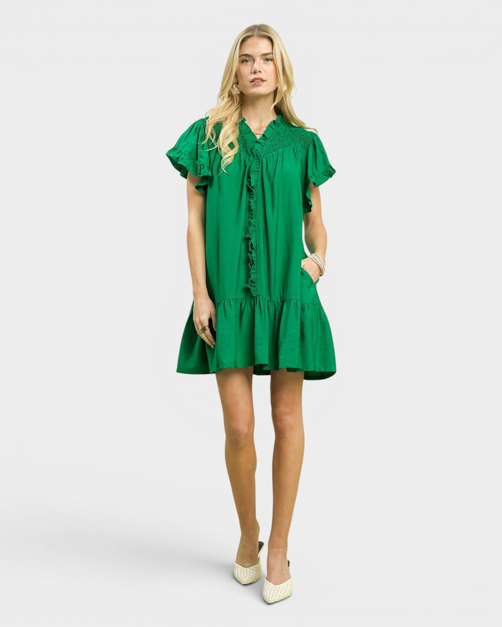 Woman wearing a green dress on a white background