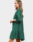 Woman wearing a green dress on a plain background