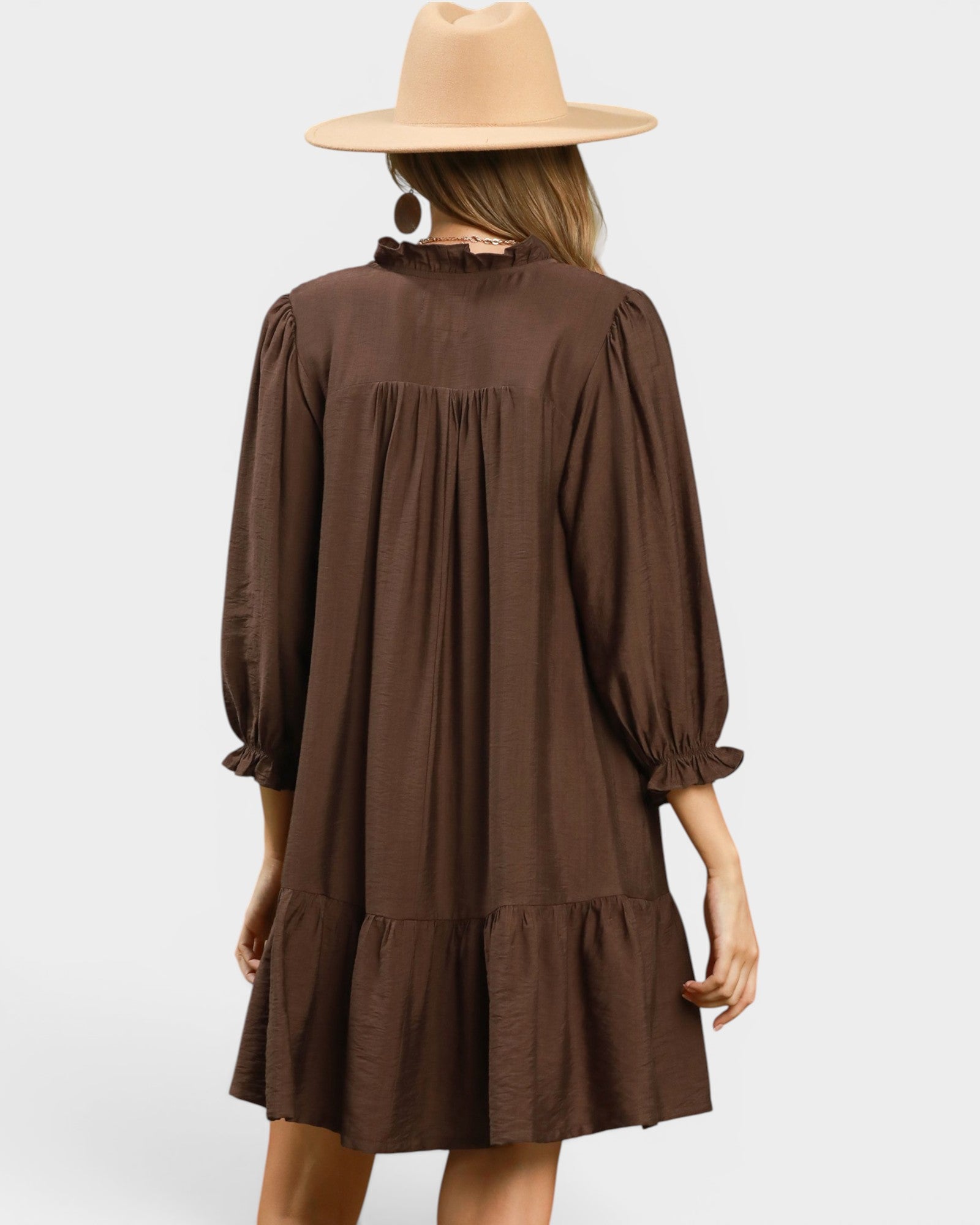 Brown dress with long sleeves and a hat on a white background
