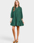 Woman wearing a green dress on a white background