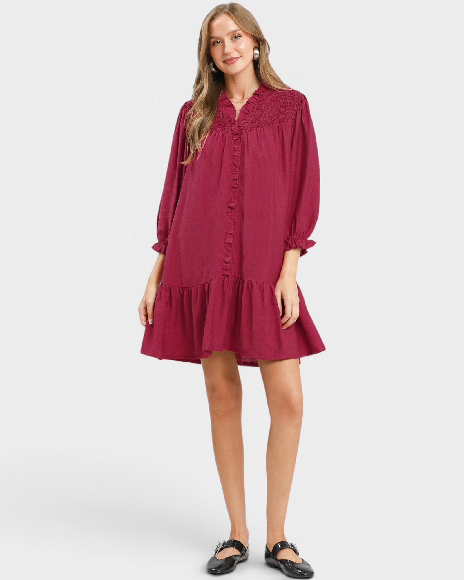Woman wearing a burgundy dress on a white background