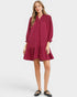 Woman wearing a burgundy dress on a white background