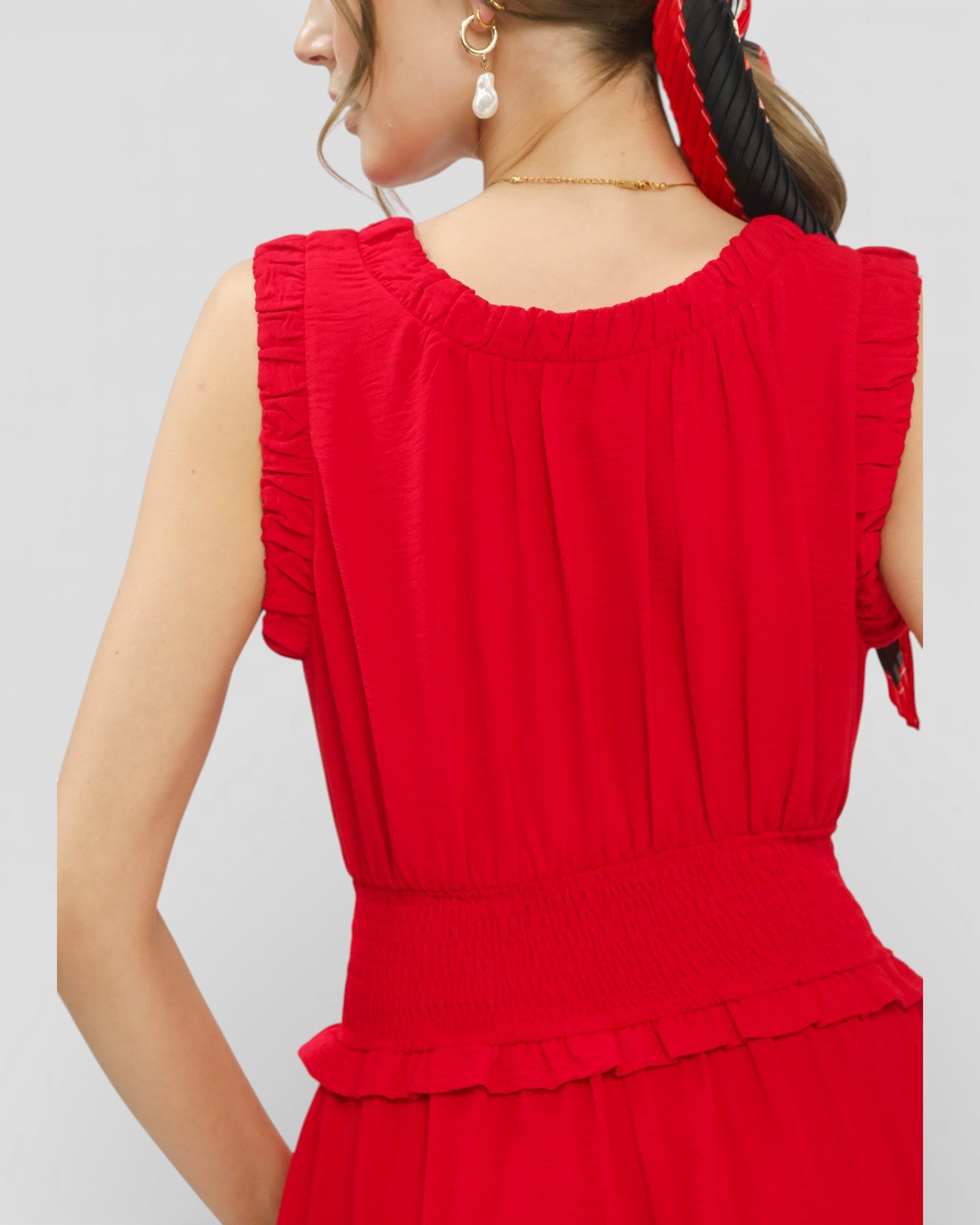 Red dress with ruffled sleeves on a plain background