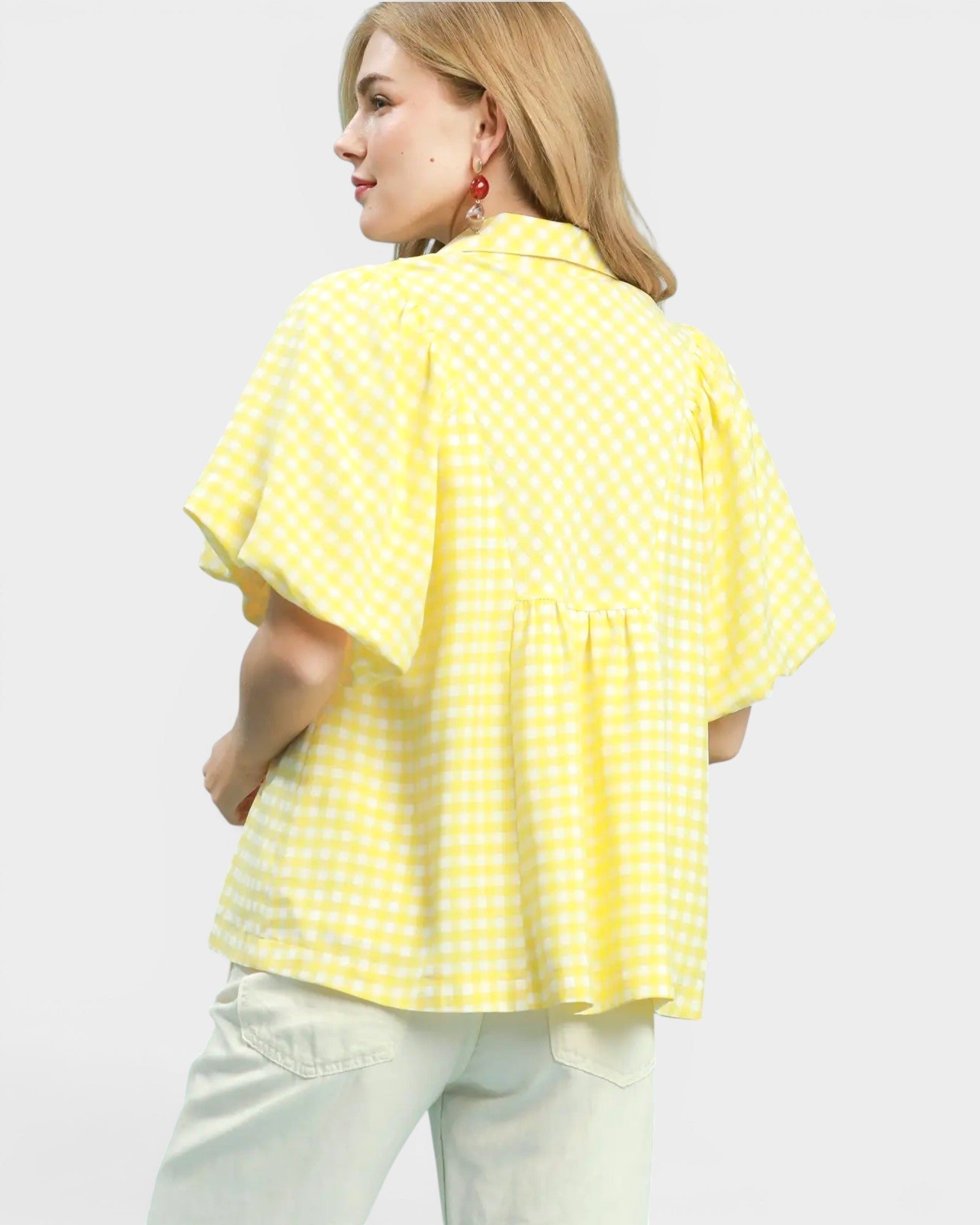 Woman wearing a yellow checkered shirt on a white background