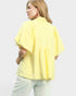 Woman wearing a yellow checkered shirt on a white background