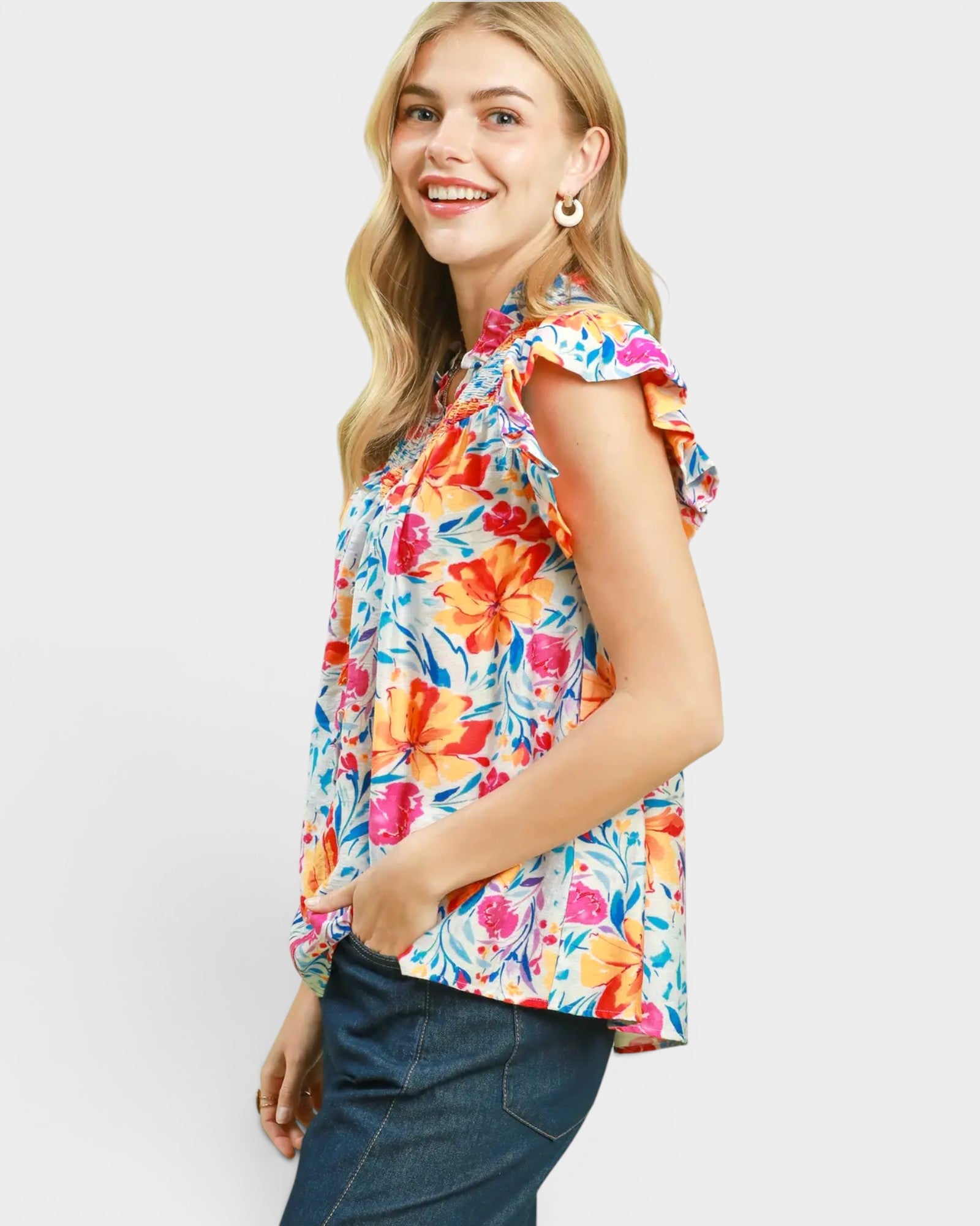 Woman wearing a colorful floral blouse on a white background