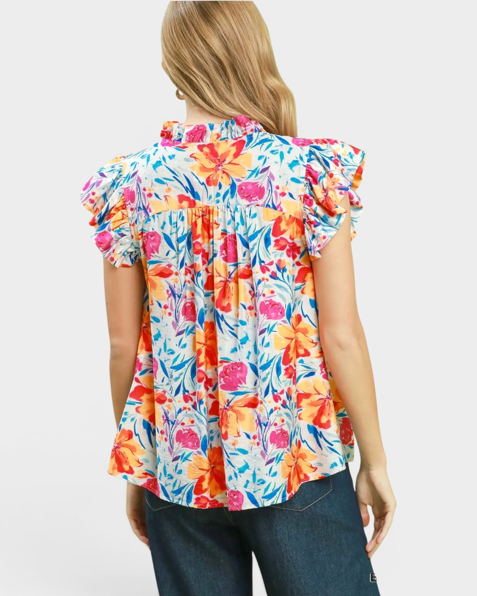 Woman wearing a colorful floral blouse on a white background
