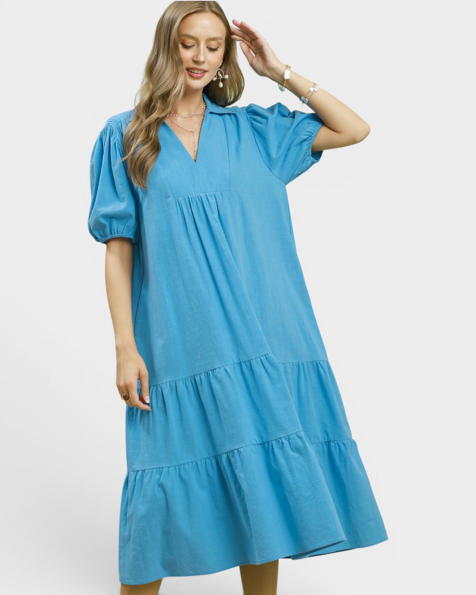 Woman wearing a blue dress on a white background
