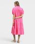 Woman wearing a bright pink dress on a white background