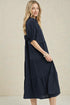 Woman wearing a navy blue dress on a beige background