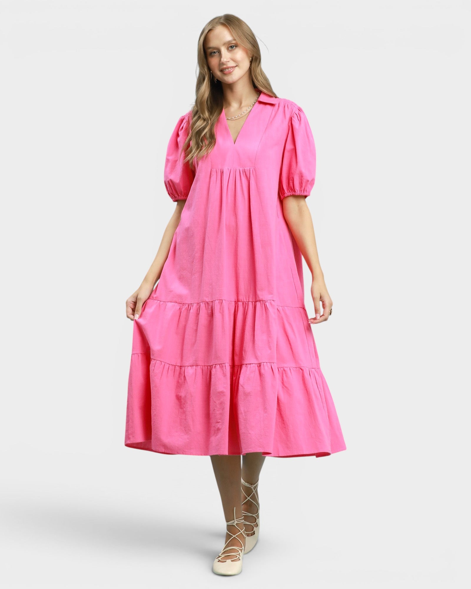 Woman wearing a pink dress on a white background