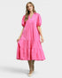 Woman wearing a pink dress on a white background