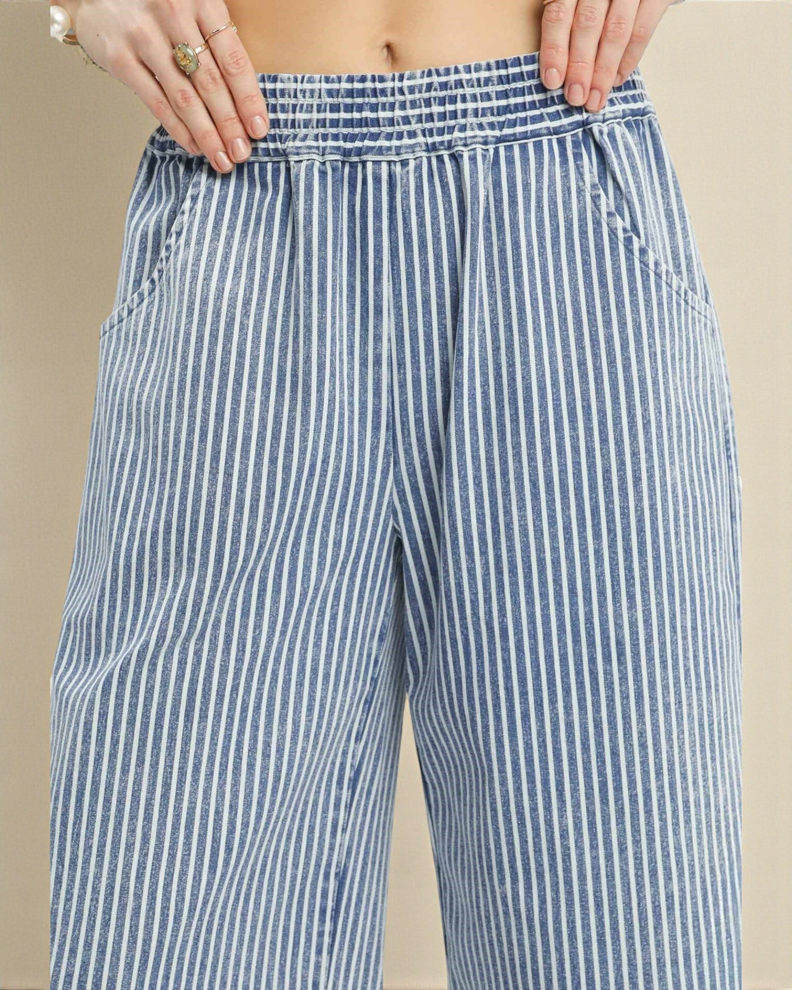 Blue and white striped pants on a beige background