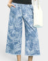 Blue patterned pants worn by a person on a white background